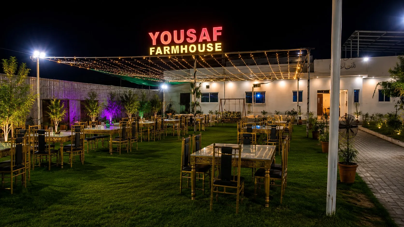 Guests relaxing on the open lawns at Yousaf Farmhouse in Faisalabad